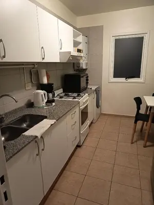 a kitchen with a sink and a stove top oven at Excelente Departamento Nueva Córdoba in Cordoba