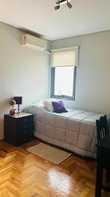 a bed in a room with a window at Excelente Departamento Nueva Córdoba in Cordoba