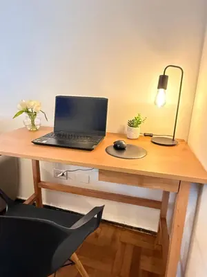 a laptop computer sitting on top of a wooden desk at Nueva Córdoba Independencia apart in Cordoba