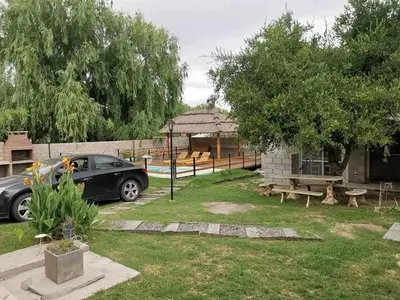 a car parked in a yard next to a building at Mi casa en tanti casa 26 in Tanti