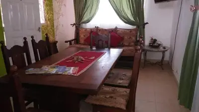 a dining room with a table and a couch at Mi casa en tanti casa 26 in Tanti