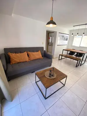 a living room with a couch and a table at EfeCalm Entre Ríos in Cordoba