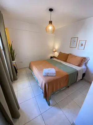 a bedroom with a bed and a potted plant at EfeCalm Entre Ríos in Cordoba