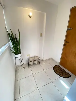 a hallway with a door and a potted plant at EfeCalm Entre Ríos in Cordoba