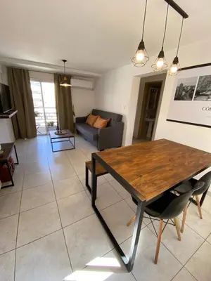 a living room with a table and a couch at EfeCalm Entre Ríos in Cordoba
