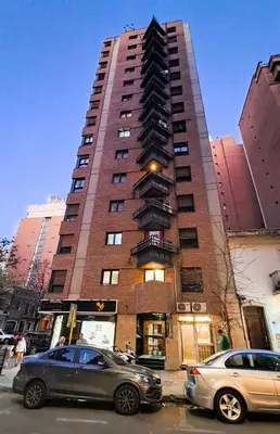 a tall building with cars parked in front of it at Cordoba Vibe in Cordoba