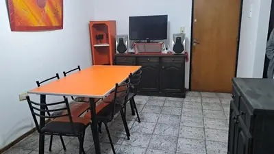 a dining room with a table and chairs and a television at Cordoba Vibe in Cordoba