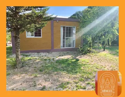 a house with a sprinkler in front of a tree at Complejo Genesis MALLIN in Cueva de los Pajaritos