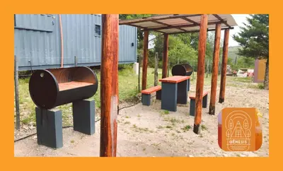 a group of benches sitting under a pergola at Complejo Genesis MALLIN in Cueva de los Pajaritos