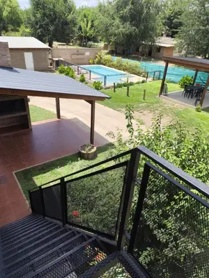 a view of a swimming pool from the balcony of a house at Departamentos Pura Fe in Santa Rosa de Calamuchita