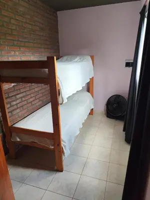 two bunk beds in a room with a brick wall at Departamentos Pura Fe in Santa Rosa de Calamuchita