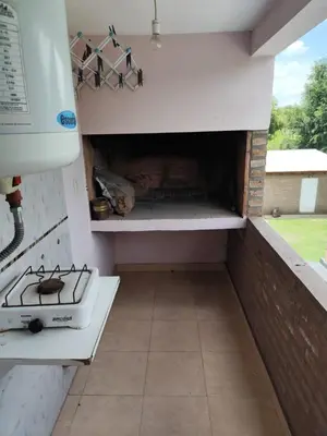 an outdoor kitchen with a stove and an oven at Departamentos Pura Fe in Santa Rosa de Calamuchita