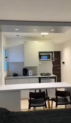a kitchen with a table and chairs in a room at MonoambienteXdia in Villa Dolores