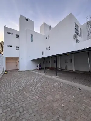 a large white building with a brick courtyard at MonoambienteXdia in Villa Dolores