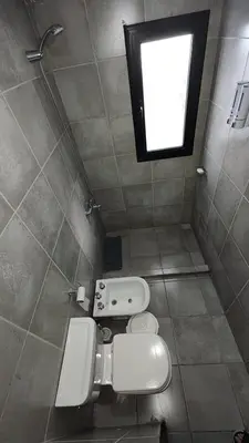 a small bathroom with a toilet and a window at Calixto C in Cordoba