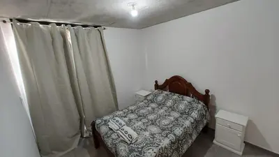 a small bedroom with a bed and curtains at Calixto C in Cordoba