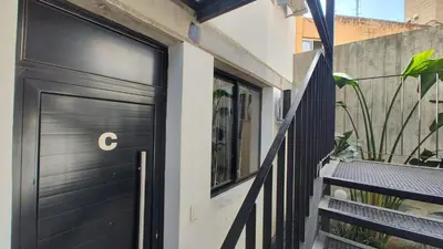 a black door with a letter on it on a building at Calixto C in Cordoba