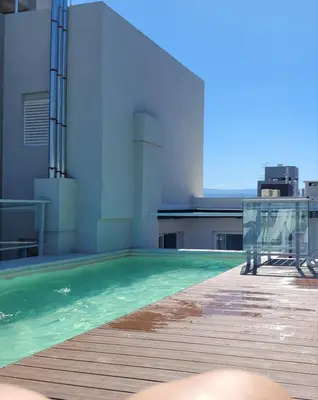 a swimming pool on the roof of a building at BERENICE IV excelente ubicación in Villa Carlos Paz