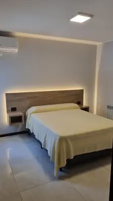 a bedroom with a large bed in a room at BERENICE IV excelente ubicación in Villa Carlos Paz