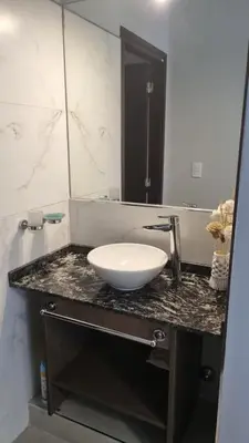 a bathroom with a white sink and a mirror at BERENICE IV excelente ubicación in Villa Carlos Paz
