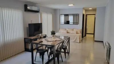 a living room with a table and a couch at BERENICE IV excelente ubicación in Villa Carlos Paz