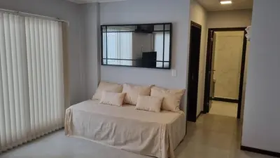 a bedroom with a bed with a mirror on the wall at BERENICE IV excelente ubicación in Villa Carlos Paz