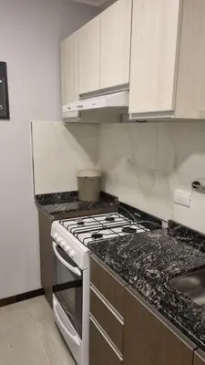 a kitchen with a stove and a counter top at BERENICE IV excelente ubicación in Villa Carlos Paz