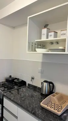 a kitchen with a stove and a counter top at Cuidad Gama Luxury - 2 Dormitorios in Cordoba