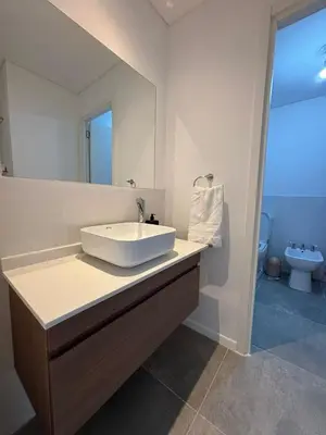 a bathroom with a white sink and a toilet at Cuidad Gama Luxury - 2 Dormitorios in Cordoba