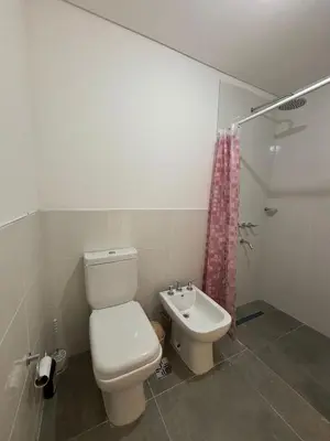 a bathroom with a toilet and a sink at Cuidad Gama Luxury - 2 Dormitorios in Cordoba