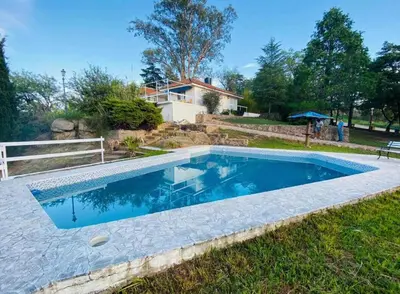 a swimming pool in a yard with a house at Casa con Piscina y Vista al Lago in Villa Santa Cruz del Lago