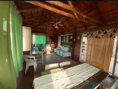 a living room with a large bed and a couch at Casa con Piscina y Vista al Lago in Villa Santa Cruz del Lago