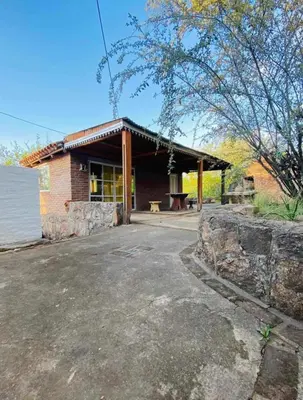 a brick building with a bench in front of it at Casa con Piscina y Vista al Lago in Villa Santa Cruz del Lago
