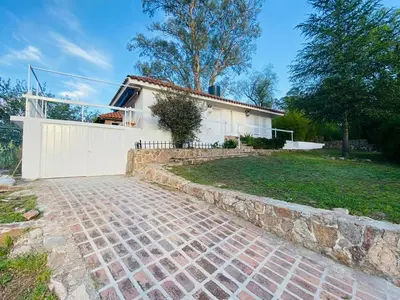 a house with a brick path in front of a house at Casa con Piscina y Vista al Lago in Villa Santa Cruz del Lago