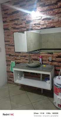 a bathroom counter with a sink in front of a brick wall at Lo de Antó in Cavalango