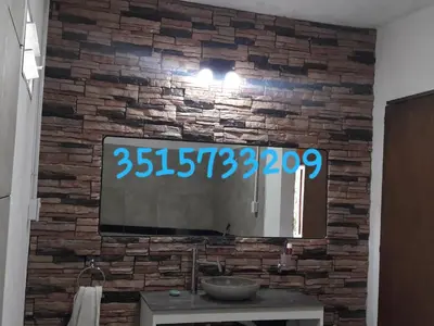 a television on a brick wall in a room at Lo de Antó in Cavalango