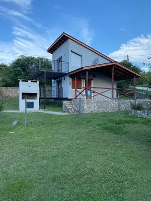 a house with a large yard in front of it at Brisas Serranas in Villa Icho Cruz