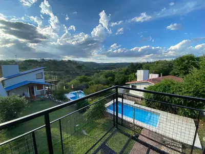 a view from the balcony of a villa with a swimming pool at Brisas Serranas in Villa Icho Cruz