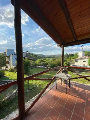 a view from the porch of a house with a bench at Brisas Serranas in Villa Icho Cruz