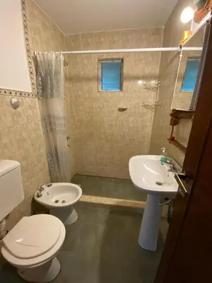 a bathroom with a toilet and a sink and a shower at Brisas Serranas in Villa Icho Cruz