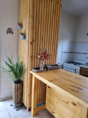 a kitchen with a wooden table in a room at Ventura 1 in Villa Carlos Paz