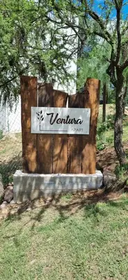 a sign that says vermont on the side of a tree at Ventura 1 in Villa Carlos Paz