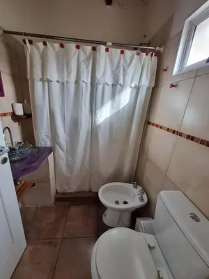 a small bathroom with a toilet and a sink at Ventura 1 in Villa Carlos Paz