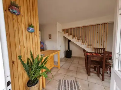 a living room with a staircase and a table at Ventura 1 in Villa Carlos Paz