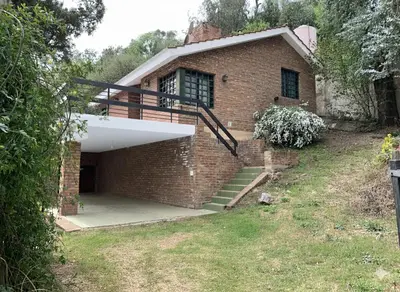 a brick house with a staircase in front of it at La Morada de sus Sueños II in San Roque