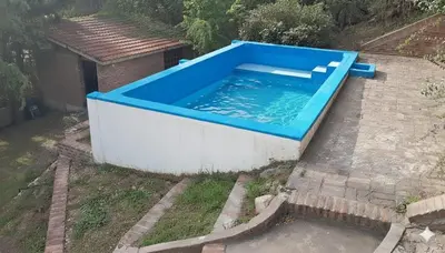 a swimming pool with a blue top on a patio at La Morada de sus Sueños II in San Roque