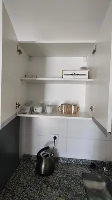 a tea kettle sitting on the floor in a kitchen at Habitana Firpo Cofico con cochera in Cordoba