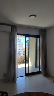 a room with a sliding glass door with a window at Habitana Firpo Cofico con cochera in Cordoba