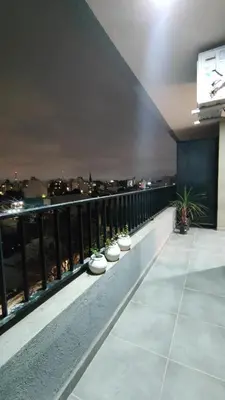a balcony with a view of a city at night at Habitana Firpo Cofico con cochera in Cordoba
