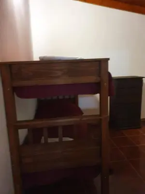 a wooden table in the corner of a room at Cabañas Sierra Maestra in Bialet Massé